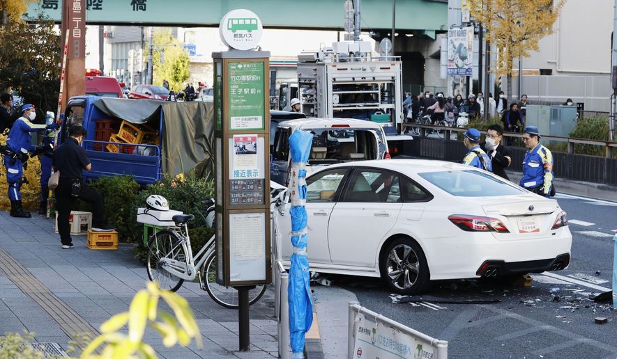 Investigators inspect the scene of a car accident injuring multiple people in Tokyo, Monday, Nov. 24, 2025. (Michi Ono/Kyodo News via AP)