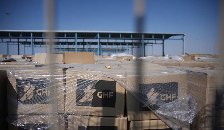 FILE - Piles of humanitarian aid packages from GHFwas, Gaza Humanitarian Foundation, wait to be picked up on the Palestinian side of the Kerem Shalom crossing in the Gaza Strip, Thursday, July 24, 2025. during a media tour organized by the Israeli army. (AP Photo/Ohad Zwigenberg, file)