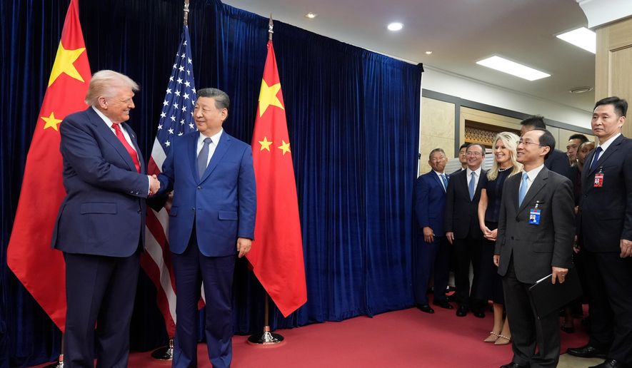 President Donald Trump, left, and Chinese President Xi Jinping shake hands before their meeting at Gimhae International Airport in Busan, South Korea, Thursday, Oct. 30, 2025. (AP Photo/Mark Schiefelbein) ** FILE **