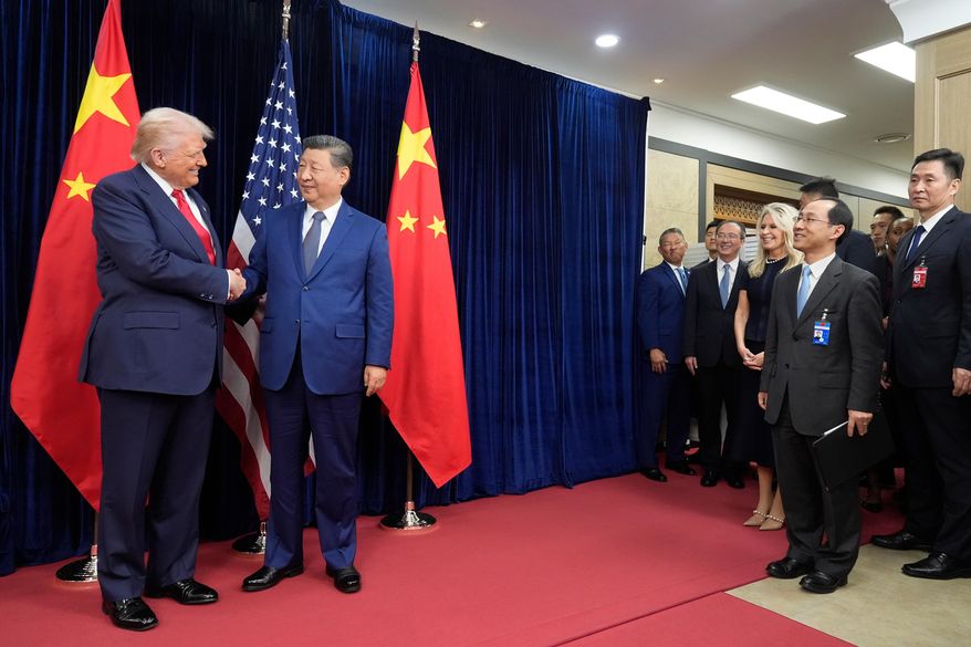 President Donald Trump, left, and Chinese President Xi Jinping shake hands before their meeting at Gimhae International Airport in Busan, South Korea, Thursday, Oct. 30, 2025. (AP Photo/Mark Schiefelbein) ** FILE **