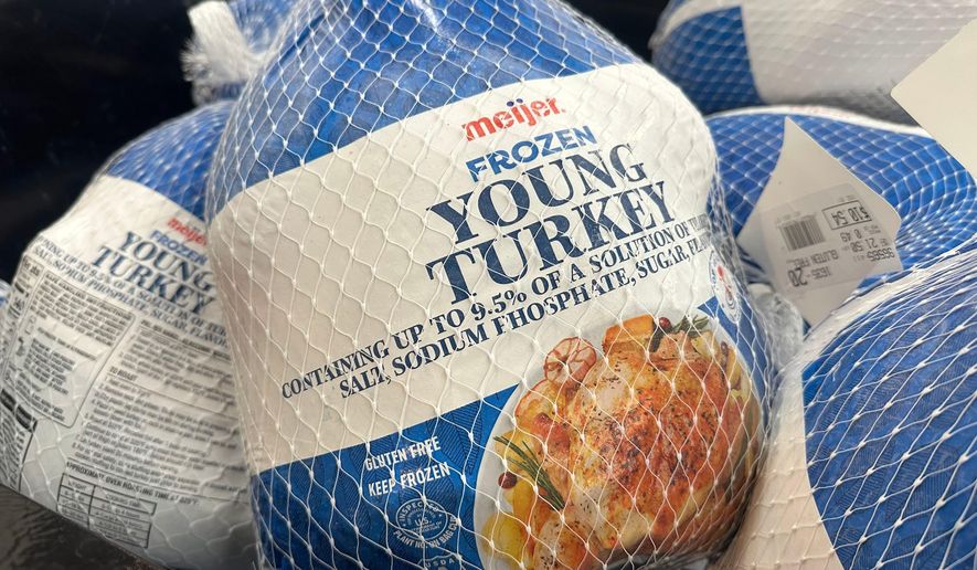 Frozen turkeys are on display at a Meijer store Friday, Nov. 21, 2025, in Canton Township, Mich. (AP Photo/Mike Householder)