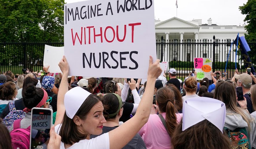 FILE - People protest outside the White House in Washington, May 12, 2022. (AP Photo/Susan Walsh)