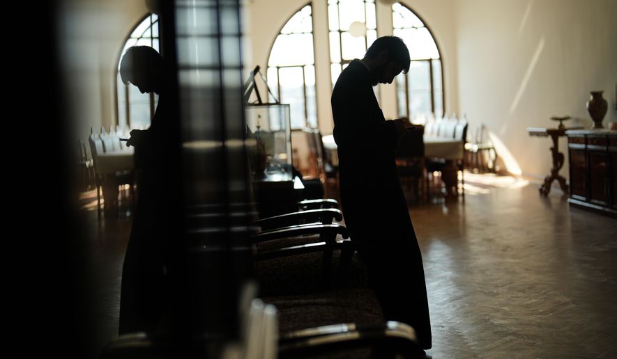 A Christian Orthodox clergy stands in one of the corridors of the Christian Orthodox Halki Theological school, at the Holy Trinity monastery, in Heybeliada island, Istanbul, Turkey, Friday, Nov. 14, 2025. (AP Photo/Francisco Seco)