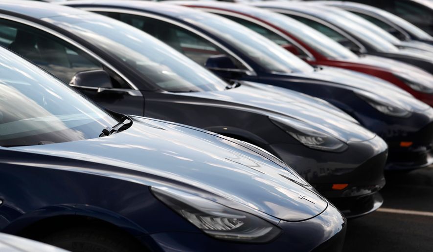 FILE - Several 2018 Model 3 sedans sit on display outside a Tesla showroom, July 8, 2018, in Littleton, Colo. (AP Photo/David Zalubowski, File)
