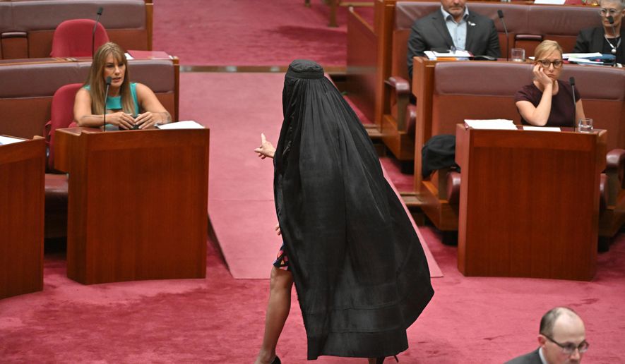 One Nation Leader Pauline Hanson wears a burqa in the Senate chamber at Parliament House in Canberra, Monday, Nov. 24, 2025. (Mick Tsikas/AAP Image via AP)