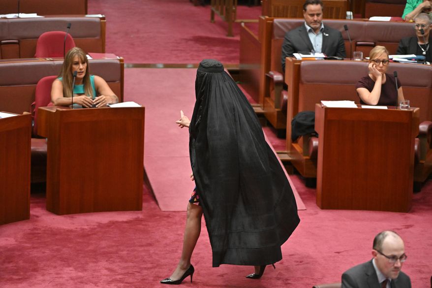 One Nation Leader Pauline Hanson wears a burqa in the Senate chamber at Parliament House in Canberra, Monday, Nov. 24, 2025. (Mick Tsikas/AAP Image via AP)