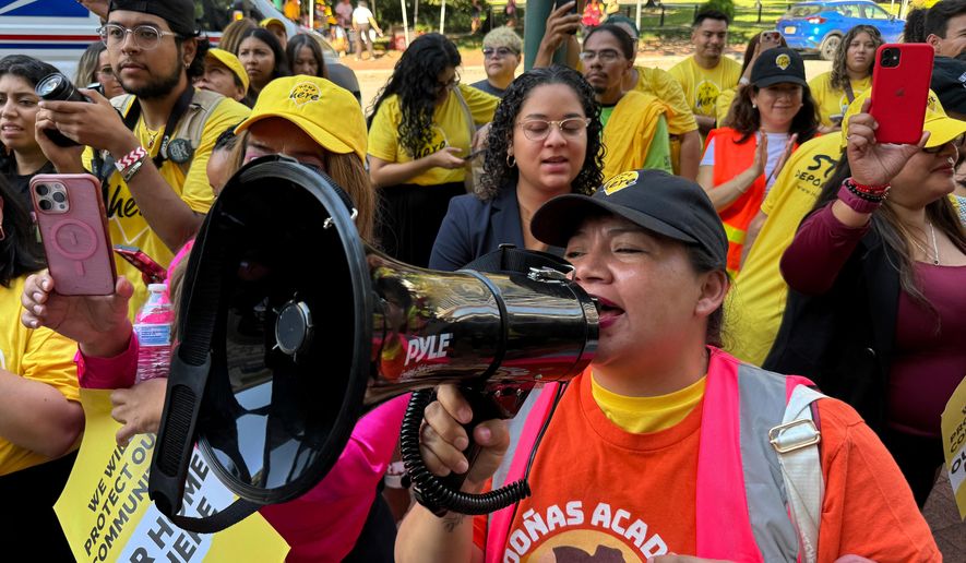 FILE - DACA supporter Claudia Valdivia wields a megaphone at a rally outside federal appeals court in New Orleans on Thursday, Oct. 10 ,2024. (AP Photo/Jack Brook, File)