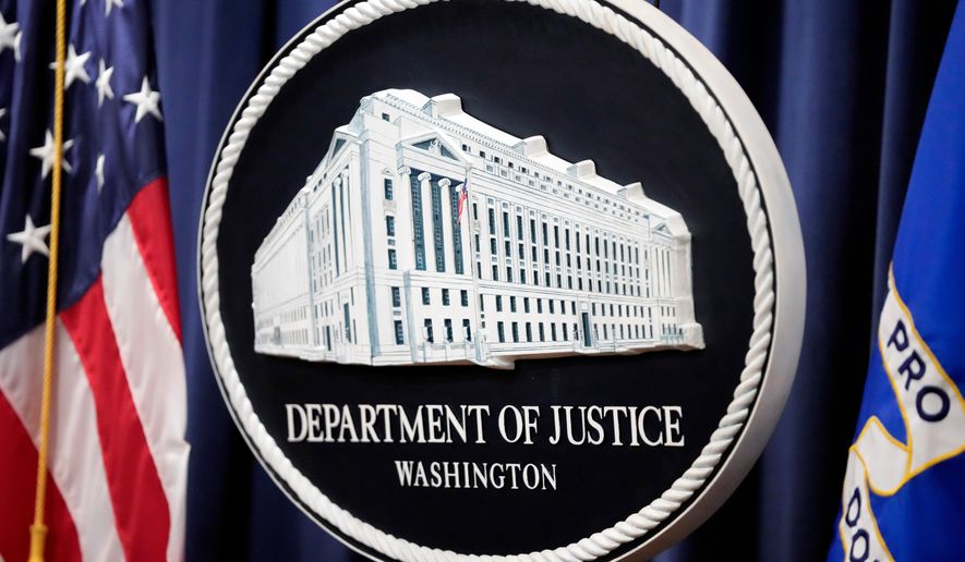 The logo for the Justice Department is seen before a news conference at the Department of Justice on Aug. 23, 2024, in Washington. (AP Photo/Mark Schiefelbein, File)