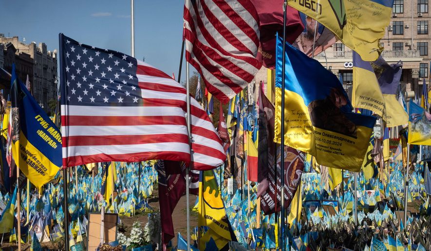 U.S. and Ukrainian national flags wave to commemorate American volunteers, who were killed in battles with Russian troops defending Ukraine, at the improvised war memorial in Independence Square in Kyiv, Ukraine, Sept. 27, 2024. (AP Photo/Efrem Lukatsky) **FILE**