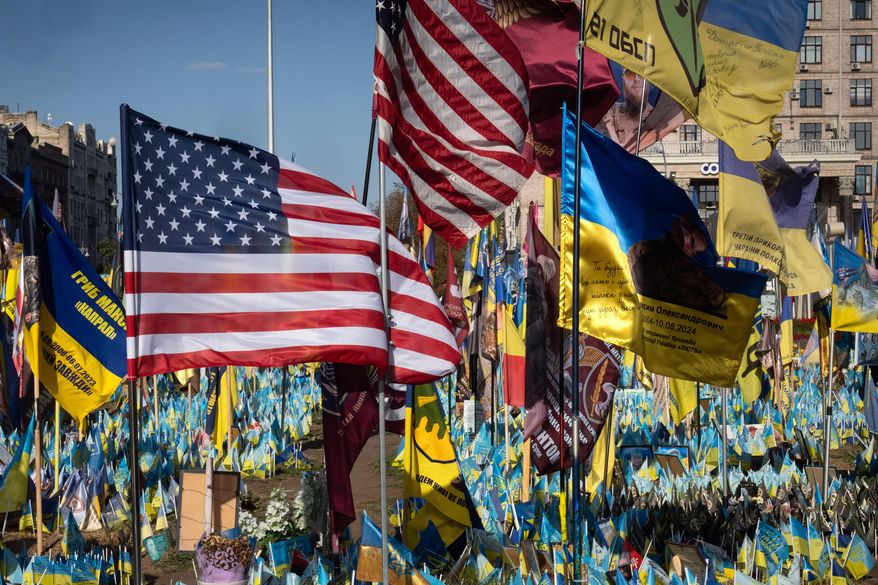 U.S. and Ukrainian national flags wave to commemorate American volunteers, who were killed in battles with Russian troops defending Ukraine, at the improvised war memorial in Independence Square in Kyiv, Ukraine, Sept. 27, 2024. (AP Photo/Efrem Lukatsky) **FILE**