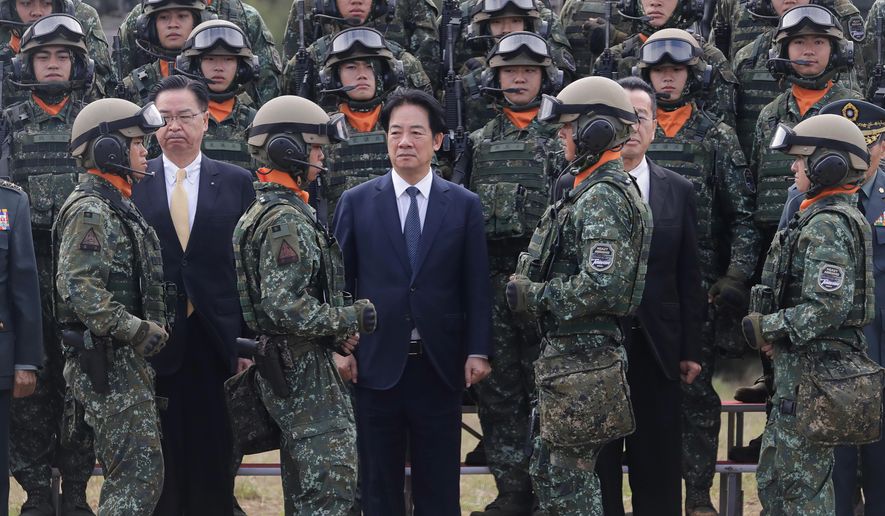 Taiwan's President Lai Ching-te, center, waits for a group photo with soldiers during the inauguration ceremony of M1A2T Abrams Main Battle Tanks in Hsinchu County, Taiwan, Friday, Oct. 31, 2025. (AP Photo/Chiang Ying-ying)