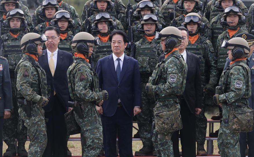 Taiwan's President Lai Ching-te, center, waits for a group photo with soldiers during the inauguration ceremony of M1A2T Abrams Main Battle Tanks in Hsinchu County, Taiwan, Friday, Oct. 31, 2025. (AP Photo/Chiang Ying-ying)
