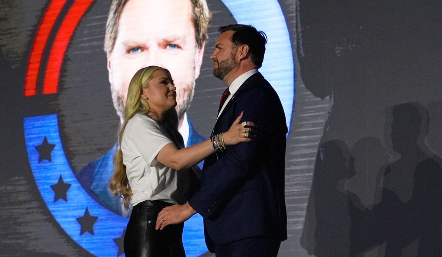 Erika Kirk, left, hugs Vice President JD Vance speaks during a "This Is the Turning Point" campus tour event at the University of Mississippi, in Oxford, Miss., Wednesday, Oct. 29, 2025. (AP Photo/Gerald Herbert)