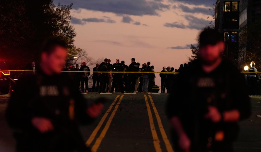 Emergency personnel keep a presence following the shooting of two National Guard soldiers near the White House, Wednesday, Nov. 26, 2025, in Washington. (AP Photo/Mark Schiefelbein)