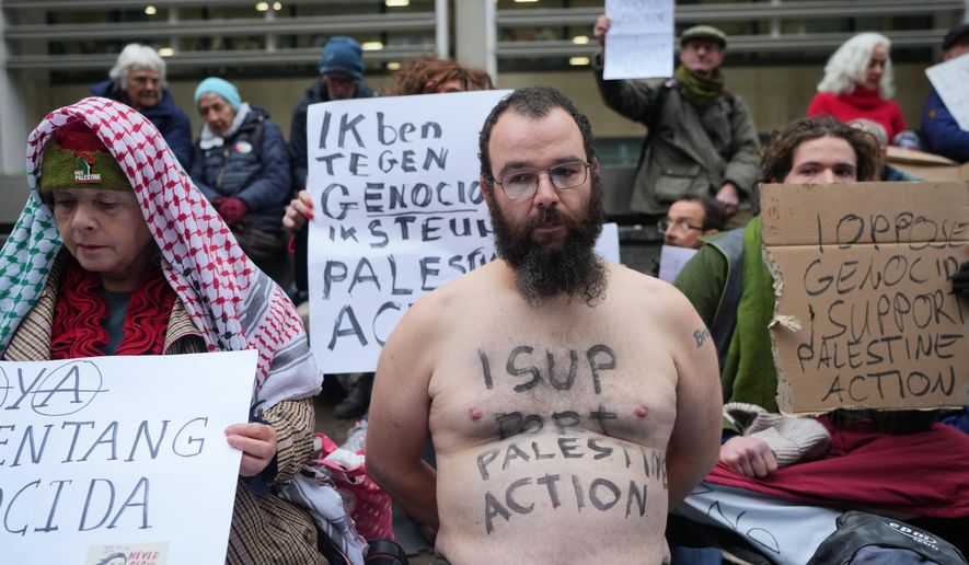 Protesters hold banners outside the Home Office during a Palestine Action demonstration in London, Monday, Nov. 24, 2025. (AP Photo/Kirsty Wigglesworth)