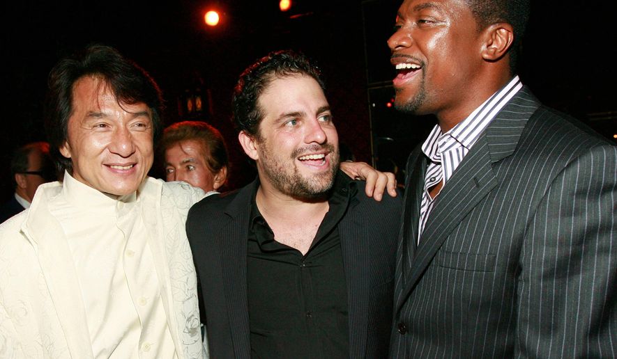 Jackie Chan, from left, Brett Ratner and Chris Tucker appear at the "Rush Hour 3" premiere after party in Los Angeles on July 30, 2007. (AP Photo/Matt Sayles, File)