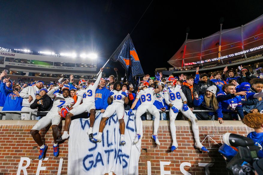 FILE -Florida players and fans celebrate after defeating Florida State in an NCAA college football game, Nov. 30, 2024, in Tallahassee, Fla. (AP Photo/Colin Hackley, File)