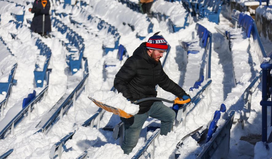 FILE - A stadium worker clears snow from seats before an NFL wild-card playoff football game between the Buffalo Bills and the Pittsburgh Steelers, Jan. 15, 2024, in Buffalo, N.Y. (AP Photo/Jeffrey T. Barnes, File)