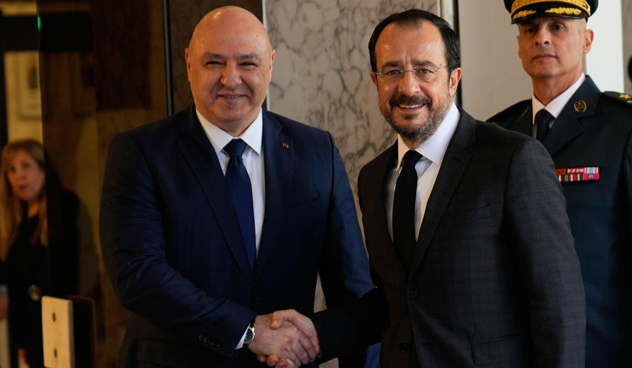 Lebanese President Joseph Aoun, left, shakes hands with Cyprus' President Nikos Christodoulides upon his arrival at the Presidential Palace in Baabda, east of Beirut, Lebanon, Wednesday, Nov. 26, 2025. (AP Photo/Hussein Malla)