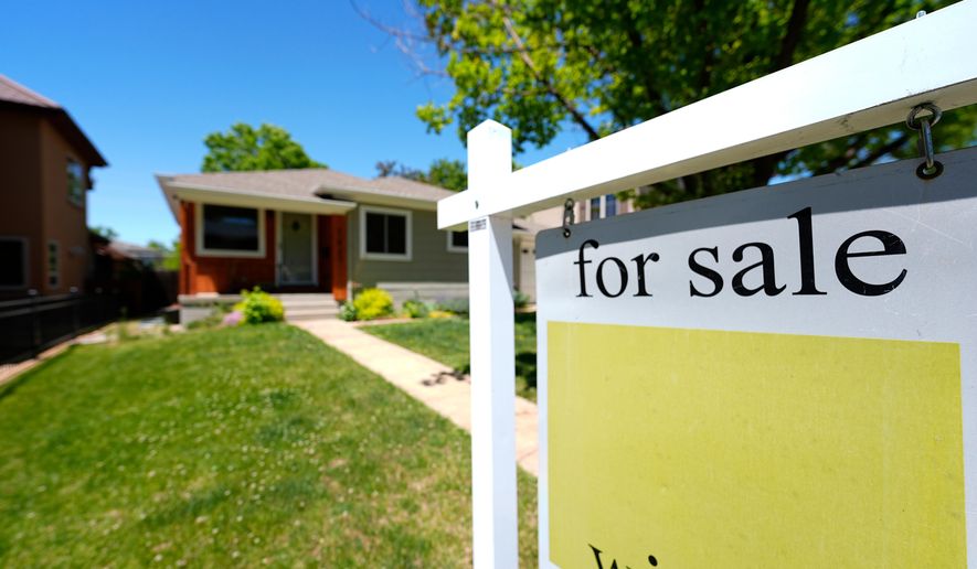 A for sale sign stands outside a single-family residence on the market May 22, 2024, in southeast Denver. (AP Photo/David Zalubowski, File)