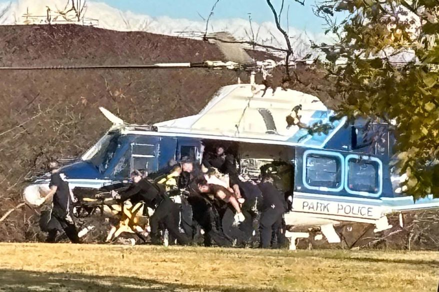 A U.S. Capitol Park Police helicopter is seen on the National Mall evacuating a National Guard shooting victim, Wednesday, Nov. 26, 2025 in Washington. (AP Photo/Emily Hanson)