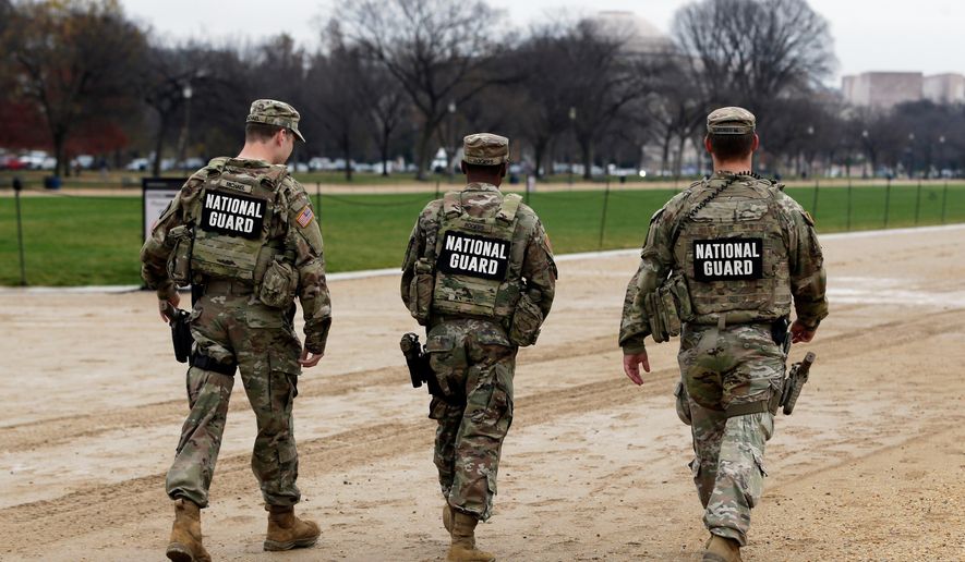 National Guard patrol on the National Mall near the U.S. Capitol, Wednesday, Nov. 26, 2025, in Washington. (AP Photo/Rahmat Gul)