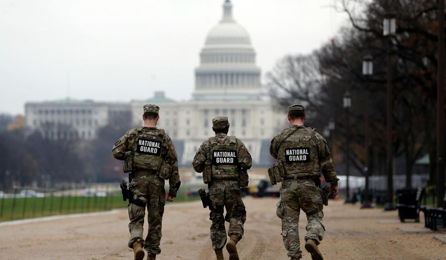 National Guard patrol along the National Mall in front of the Capitol, Wednesday, Nov. 26, 2025, in Washington. (AP Photo/Rahmat Gul)