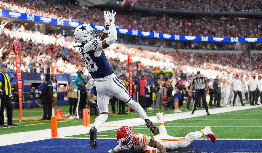 Dallas Cowboys wide receiver CeeDee Lamb (88) catches a touchdown pass as Kansas City Chiefs cornerback Trent McDuffie (22) defends during the first half of an NFL football game Thursday, Nov. 27, 2025, in Arlington, Texas. (AP Photo/Tony Gutierrez)