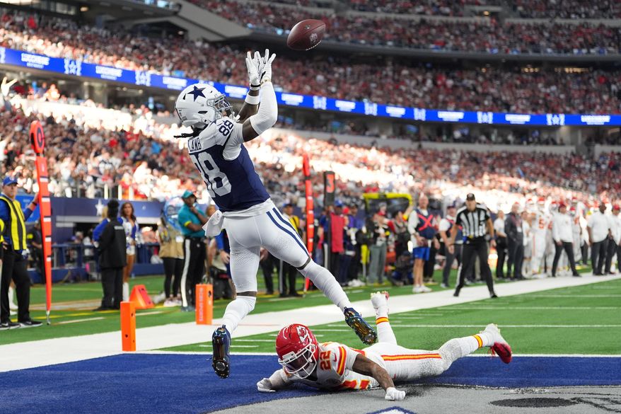 Dallas Cowboys wide receiver CeeDee Lamb (88) catches a touchdown pass as Kansas City Chiefs cornerback Trent McDuffie (22) defends during the first half of an NFL football game Thursday, Nov. 27, 2025, in Arlington, Texas. (AP Photo/Tony Gutierrez)