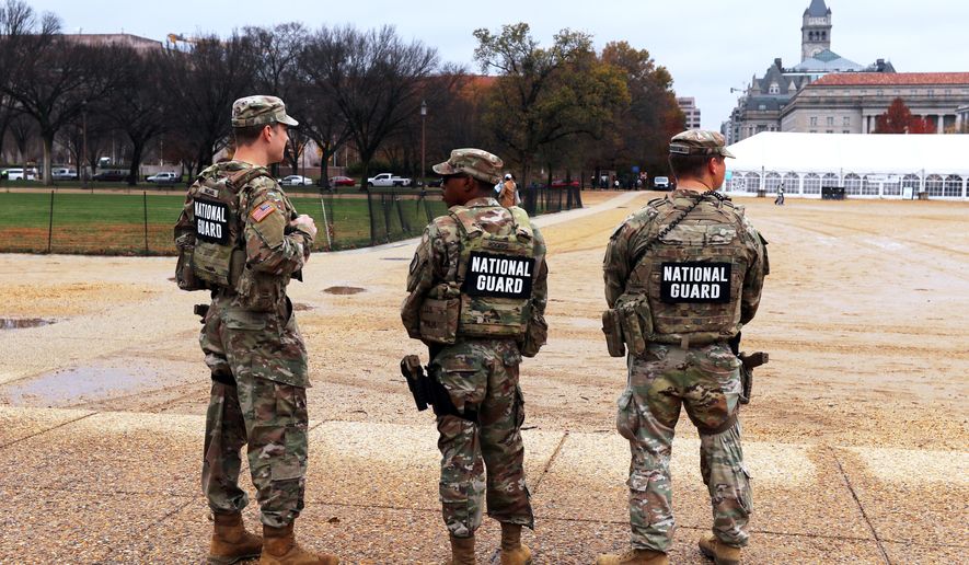 National Guard patrol on the National Mall near the U.S. Capitol, Wednesday, Nov. 26, 2025, in Washington. (AP Photo/Rahmat Gul)