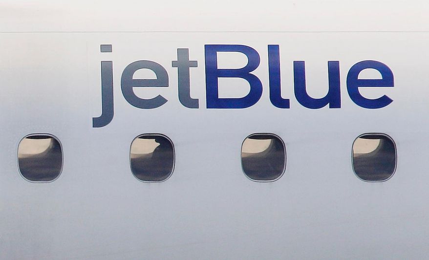 A JetBlue logo is displayed on the side of a jet as it taxis at Boston's Logan International Airport, Jan. 20, 2011. (AP Photo/Stephan Savoia, File)