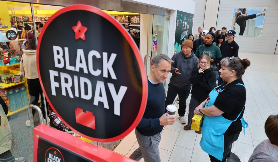 Shoppers wait in lines before they browse through stores at Mall of America for Black Friday deals, Friday, Nov. 28, 2025, in Bloomington, Minn. (AP Photo/Adam Bettcher)