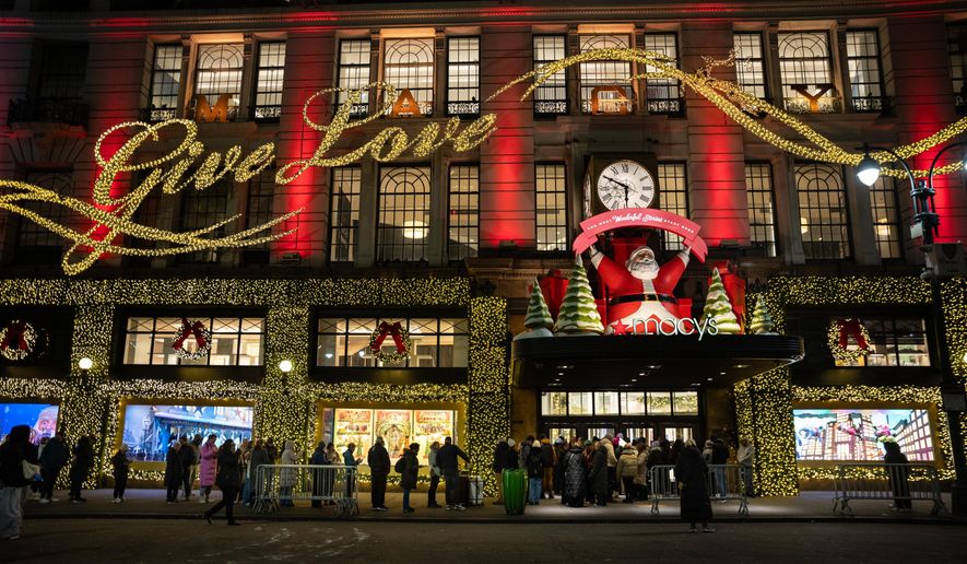 Black Friday Shoppers wait in line to enter Macy's flagship store on Friday, Nov. 28, 2025 in New York. (AP Photo/Angelina Katsanis)