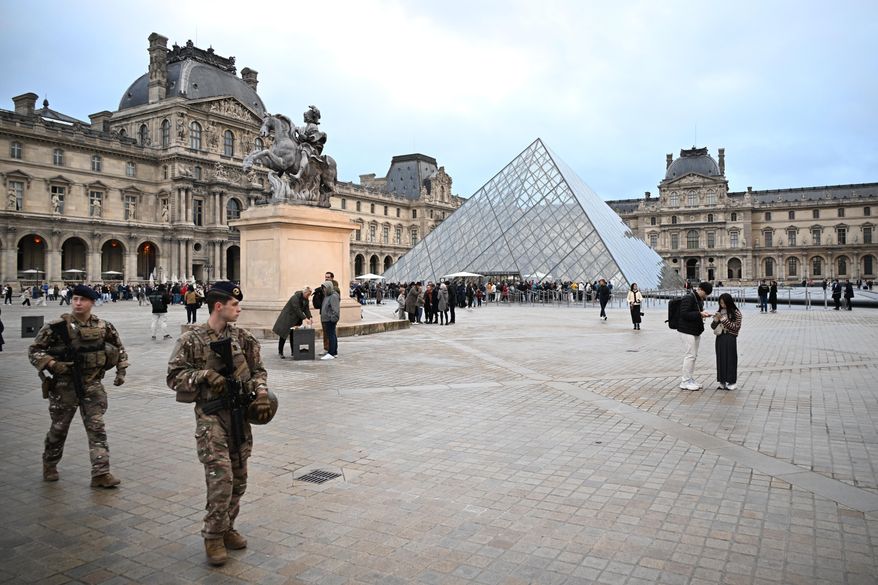 Soldiers patrol as people queue to try to enter the Louvre museum, although it remains closed for the day after Sunday's jewels robbery, Monday, Oct. 20, 2025 in Paris. (AP Photo/Emma Da Silva, File)