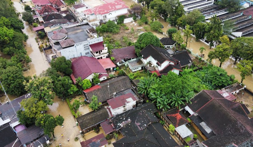 This aerial shot taken using a drone shows a flooded neighborhood in Medan, North Sumatra, Indonesia, Friday, Nov. 28, 2025. (AP Photo/Binsar Bakkara)