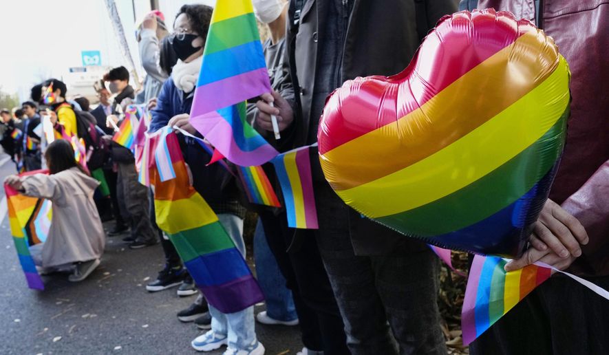 People gather outside a high court before its ruling on same-sex marriage in Tokyo, Friday, Nov. 28, 2025. (Miki Matsuzaki/Kyodo News via AP)