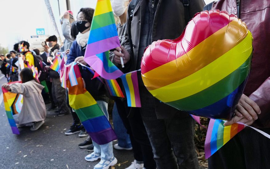 People gather outside a high court before its ruling on same-sex marriage in Tokyo, Friday, Nov. 28, 2025. (Miki Matsuzaki/Kyodo News via AP)