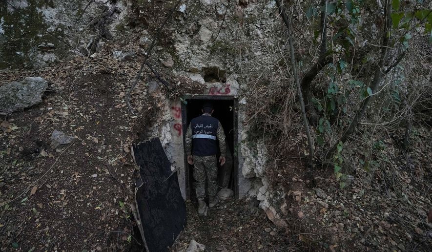A Lebanese army soldier stands at the entrance of a tunnel dug into a mountain that was used by Hezbollah militants as a clinic and storage facility near the Lebanese-Israeli border in the Zibqin Valley, southern Lebanon, Friday, Nov. 28, 2025. (AP Photo/Bilal Hussein)