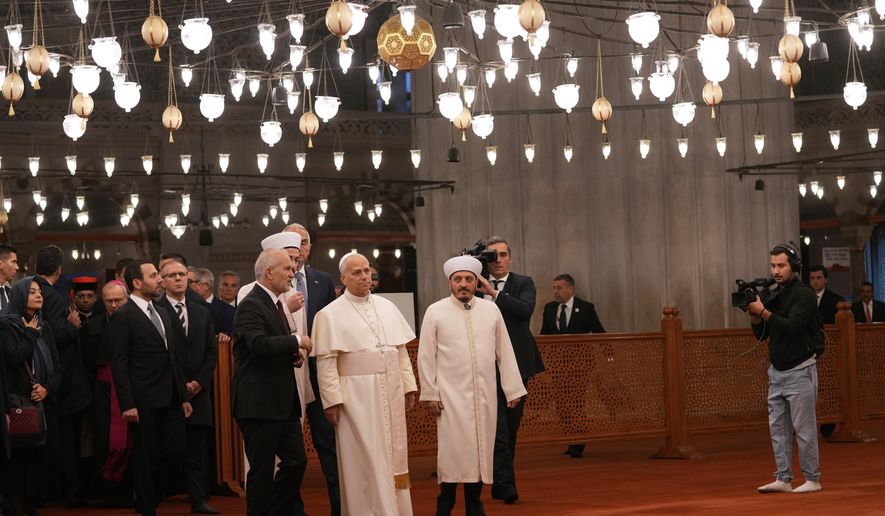 Pope Leo XIV, center, walking with Muezzin Musa Asgın Tunca, left, Dr. Emrullah Tuncel, second from left, and Imam of Mosque Sultanahmet Fatih Kaya, visits the Sultan Ahmed Mosque in Istanbul, Saturday, Nov. 29, 2025. (AP Photo/Domenico Stinellis)