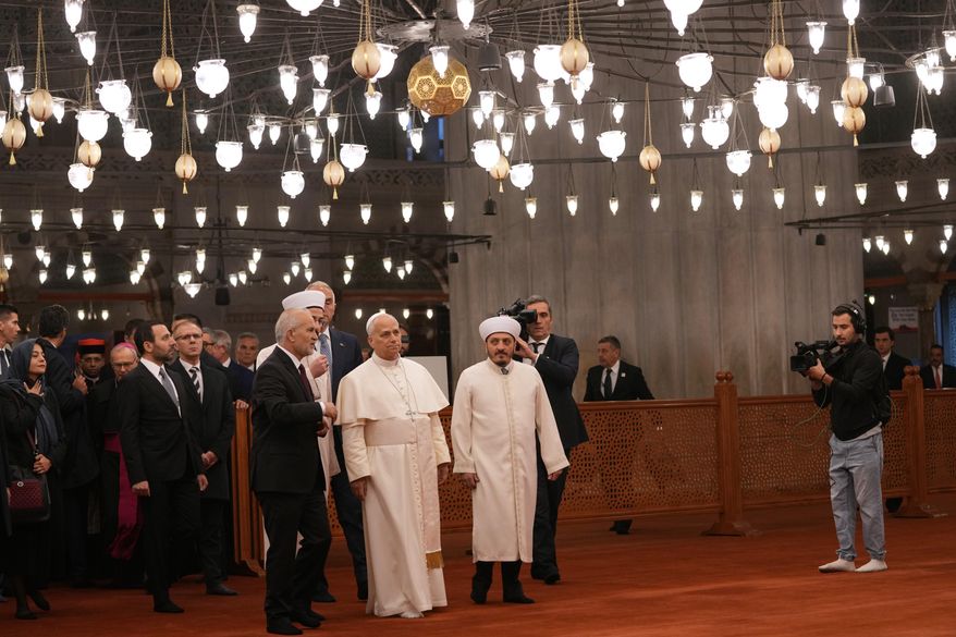 Pope Leo XIV, center, walking with Muezzin Musa Asgın Tunca, left, Dr. Emrullah Tuncel, second from left, and Imam of Mosque Sultanahmet Fatih Kaya, visits the Sultan Ahmed Mosque in Istanbul, Saturday, Nov. 29, 2025. (AP Photo/Domenico Stinellis)