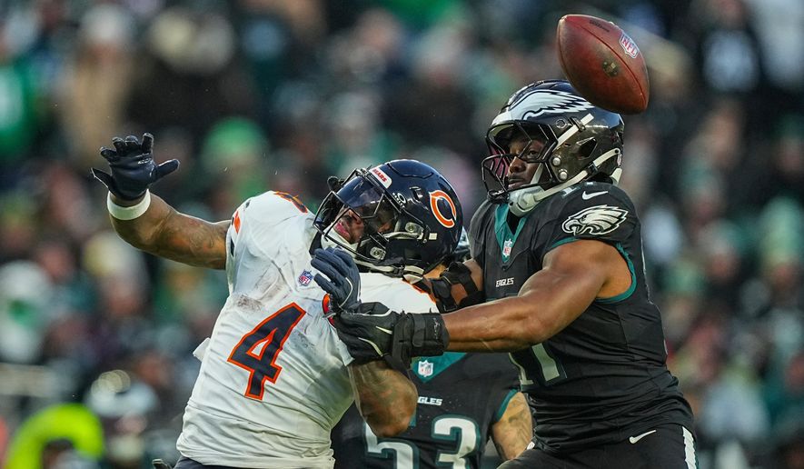 Chicago Bears running back D'Andre Swift (4), left, and Philadelphia Eagles linebacker Nakobe Dean (17) vie for a loose ball during the first half of an NFL football game, Friday, Nov. 28, 2025, in Philadelphia. (AP Photo/Matt Rourke)