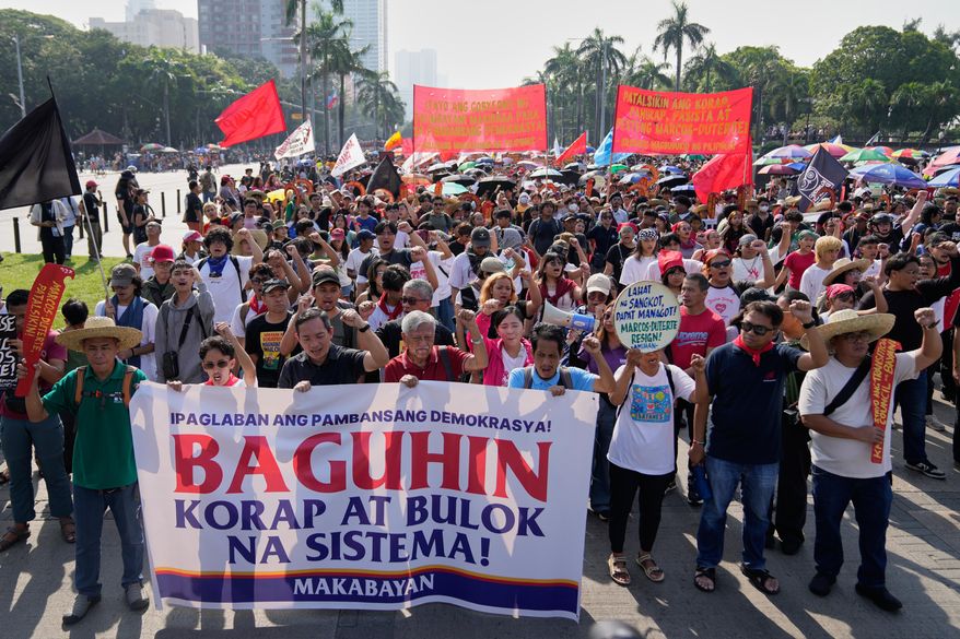 Protesters shout slogans during anti-corruption protest in Manila, Philippines on Sunday Nov. 30, 2025. (AP Photo/Aaron Favila)