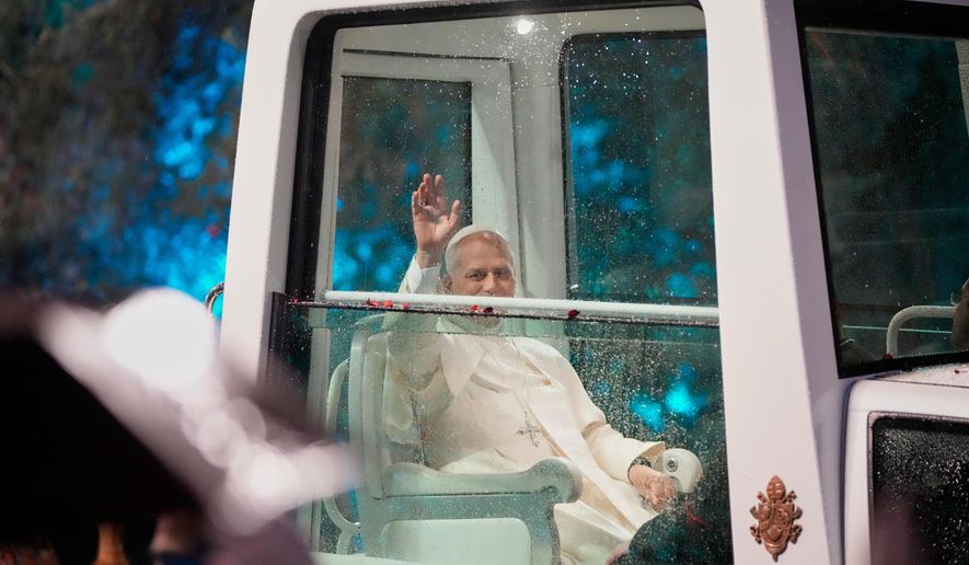 Pope Leo XIV waves as he arrives for a welcoming ceremony at the presidential palace in Baabda, east of Beirut, Lebanon, Sunday, Nov. 30, 2025.(AP Photo/Hassan Ammar)