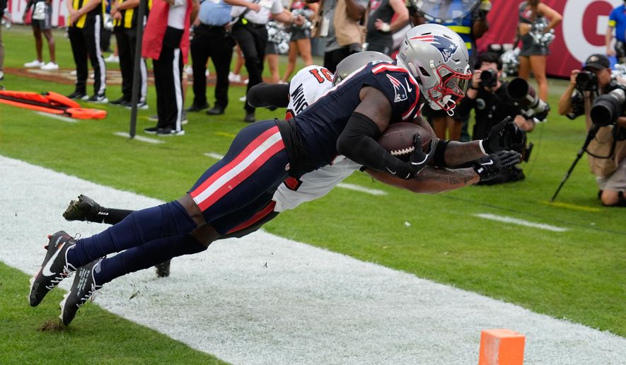 New England Patriots wide receiver Stefon Diggs (8) catches a pass for a touchdown against Tampa Bay Buccaneers safety Antoine Winfield Jr. (31) during the first half of an NFL football game Sunday, Nov. 9, 2025, in Tampa, Fla. (AP Photo/Chris O'Meara)