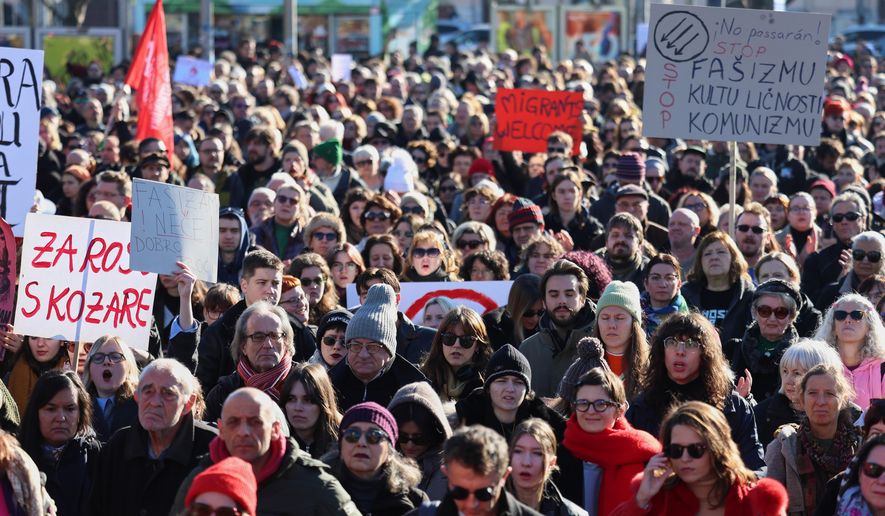 Protesters hold placards during a protest march against the surging far right following a spate of incidents targeting ethnic minorities and liberals, in Zagreb, Croatia, Sunday, Nov. 30, 2025. (AP Photo)