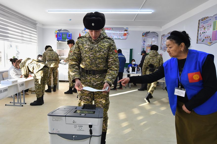 A Kyrgyz Army soldier casts his ballot during the parliamentary elections at a polling station in Tash-Dobo, 19 km (11 miles) south of Bishkek, Kyrgyzstan, Sunday, Nov. 30, 2025. (AP Photo/Vladimir Voronin)