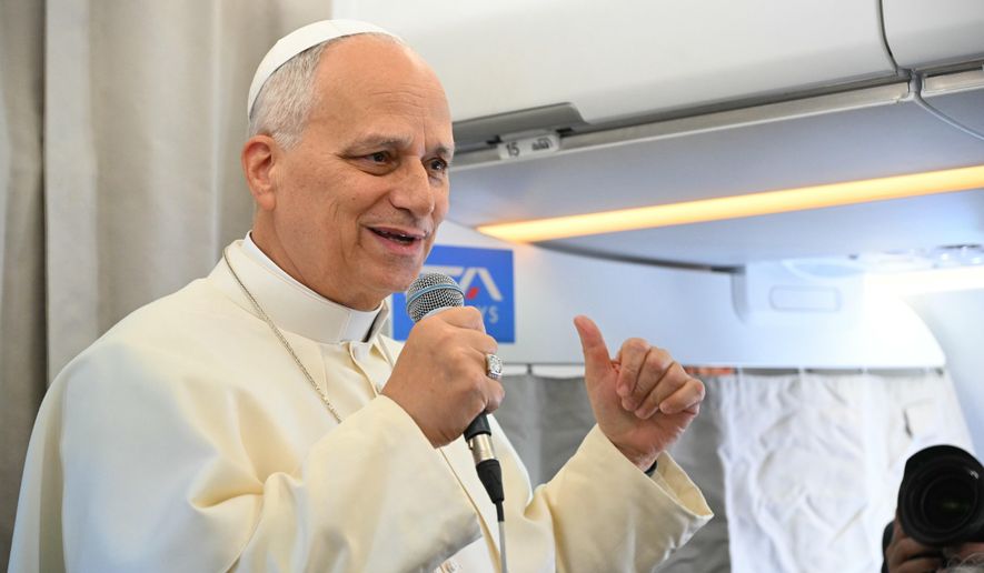 Pope Leo XIV talks to reporters aboard an aircraft on his way to Beirut, Lebanon, Sunday, Nov. 30, 2025. (Andreas Solaro/Pool Via AP)