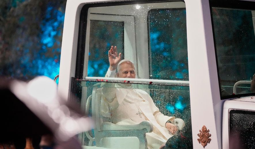 Pope Leo XIV waves as he arrives for a welcoming ceremony at the presidential palace in Baabda, east of Beirut, Lebanon, Sunday, Nov. 30, 2025.(AP Photo/Hassan Ammar)