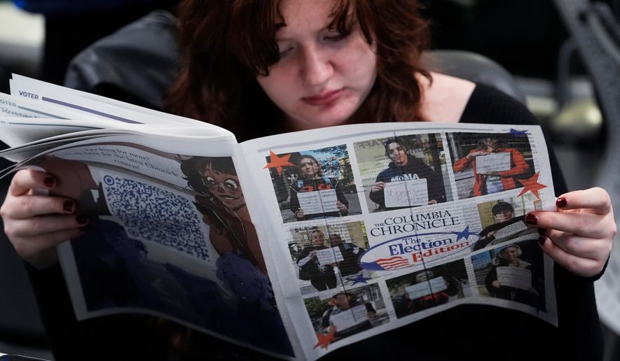 Columbia College Chicago student Kailey Ryan reads a newspaper in Chicago on Nov. 5, 2024. (AP Photo/Nam Y. Huh, File)