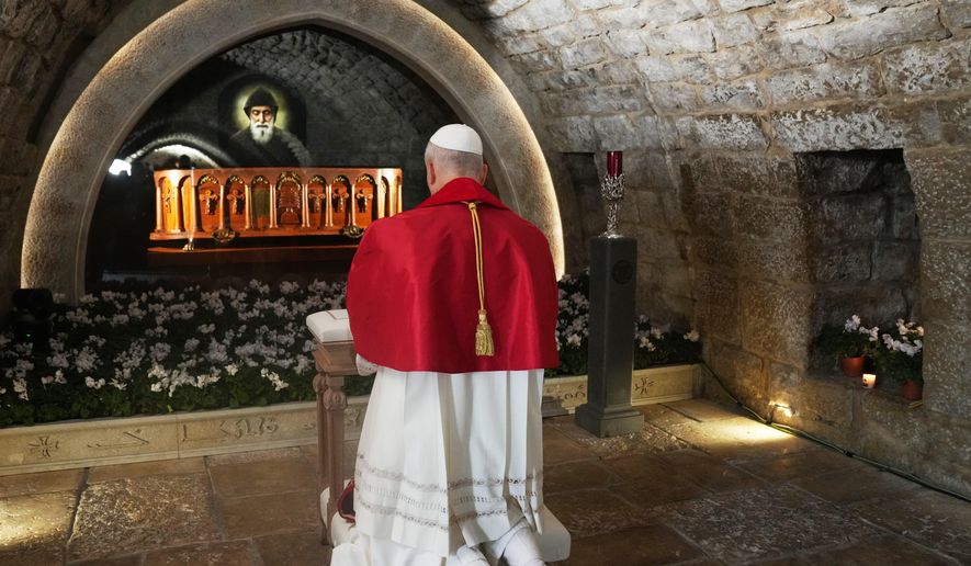 Pope Leo XIV prays in front of the tomb of St. Charbel Makhlouf at the Monastery of Saint Maroun, in Annaya, Lebanon, Monday, Dec. 1, 2025. (AP Photo/Domenico Stinellis, Pool)
